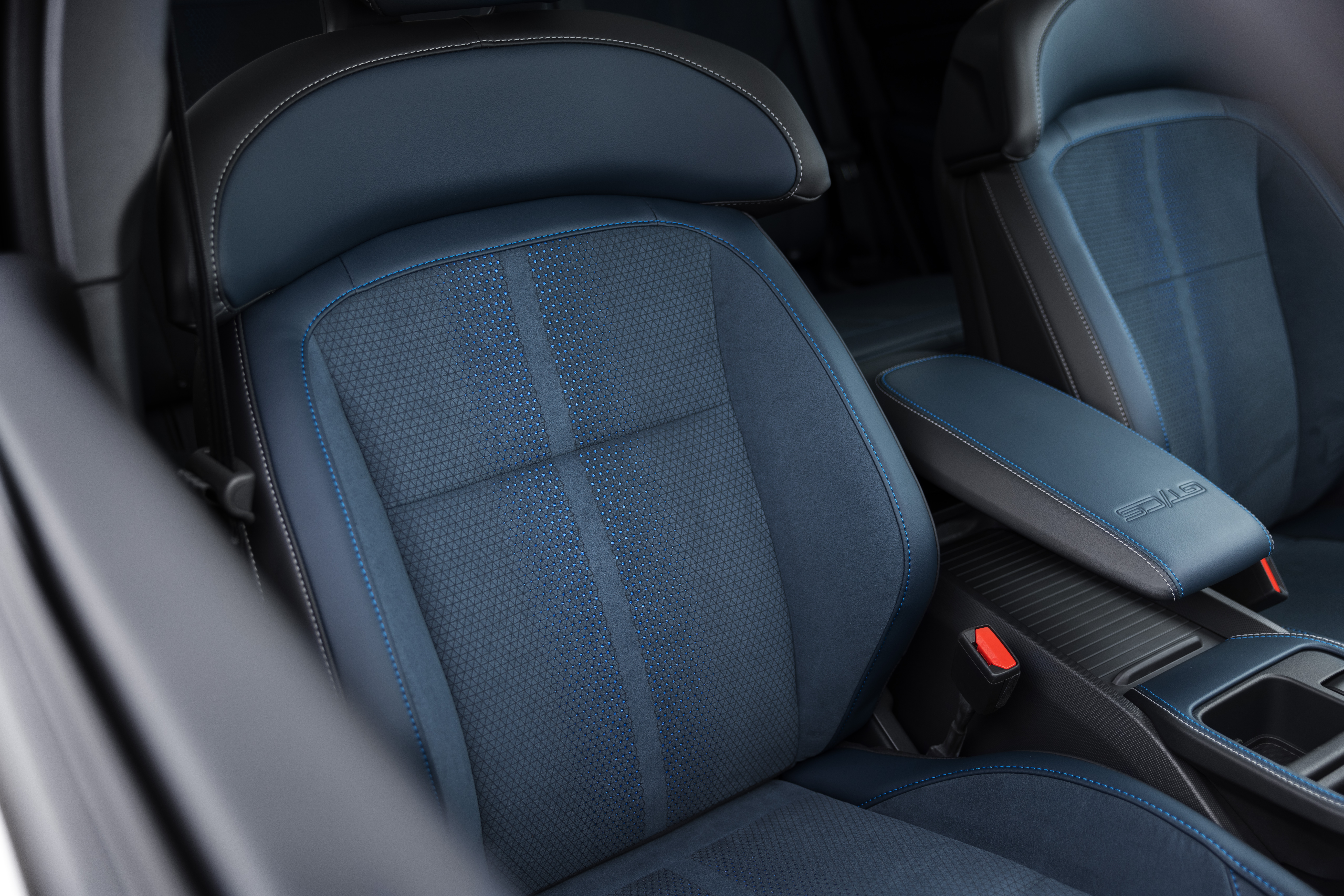 Close-up of Mustang Mach-E interior showing black and blue seat material and grey stitching.